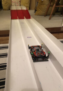 A picture showing our Mini 4WD on a brake test track setup at home