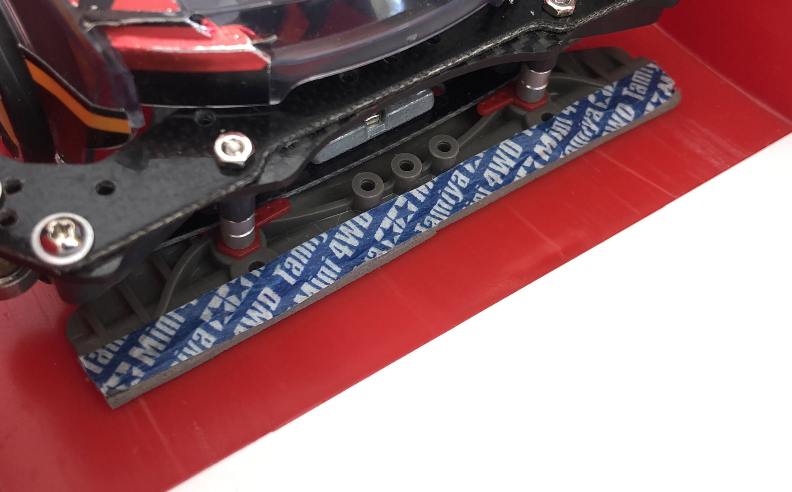 A Tamiya Mini 4WD with a rear brake mount and grey brake sponge