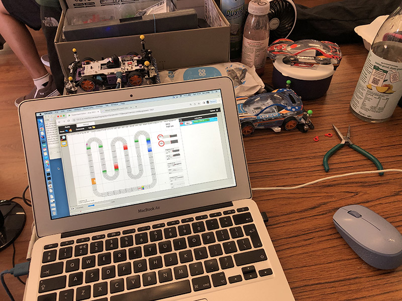My little work area at the B-MAX GP UK May 2025. Charging the car and AI computer, while replaying and visualising telemetry data collected in the race on the computer to look for improvements. Using a data driven approach.